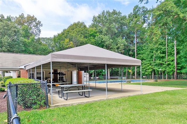 view of community featuring a lawn and a pool