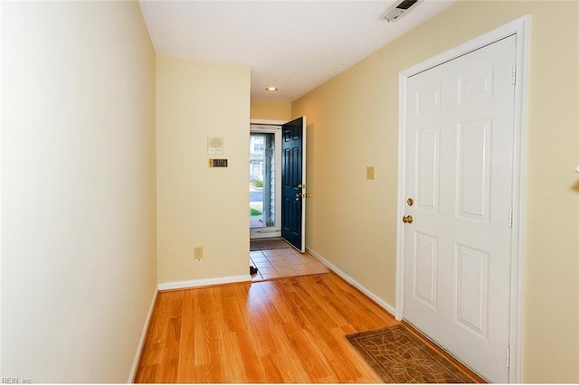 interior space featuring light hardwood / wood-style flooring and a textured ceiling