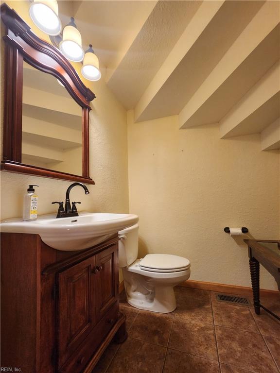 bathroom featuring vanity, toilet, and tile patterned floors