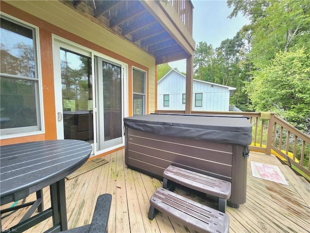 wooden terrace featuring a hot tub