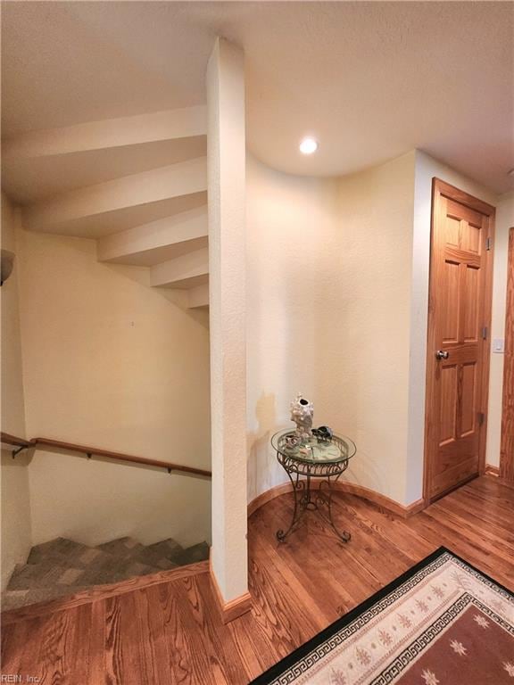 staircase with hardwood / wood-style floors