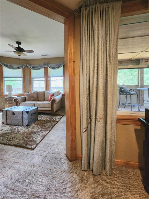 hallway featuring light colored carpet