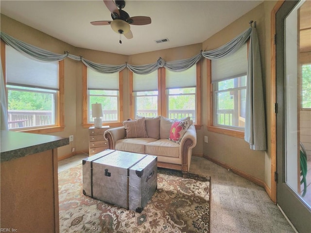 living room featuring carpet floors and ceiling fan