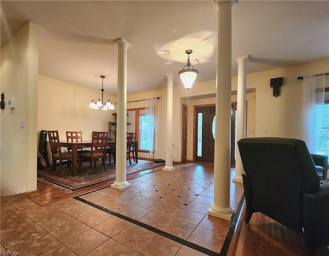 foyer with an inviting chandelier and tile patterned floors