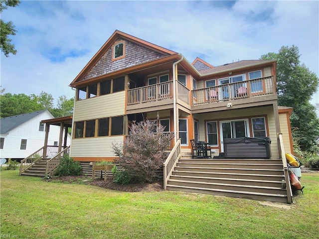 rear view of property with a balcony and a yard