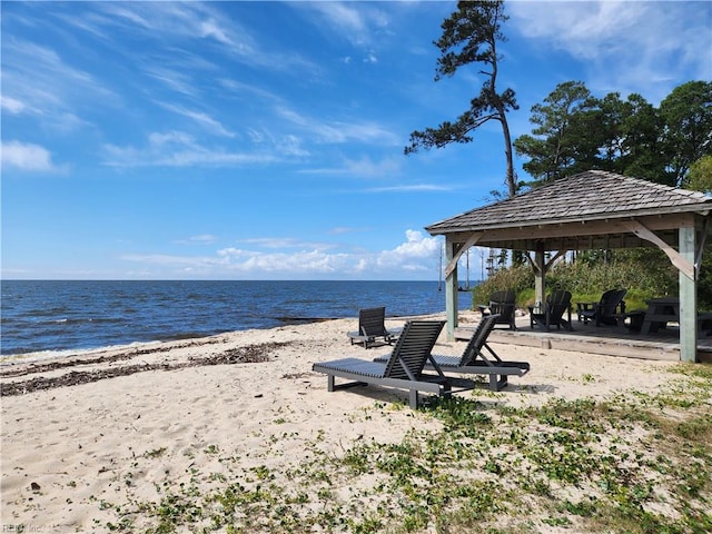 property view of water featuring a view of the beach and a gazebo