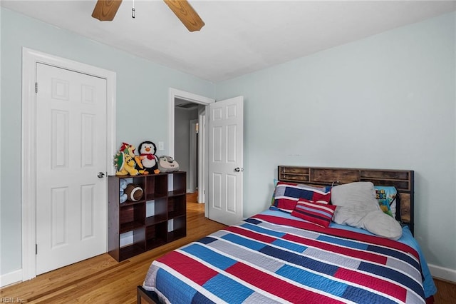 bedroom with ceiling fan and hardwood / wood-style flooring