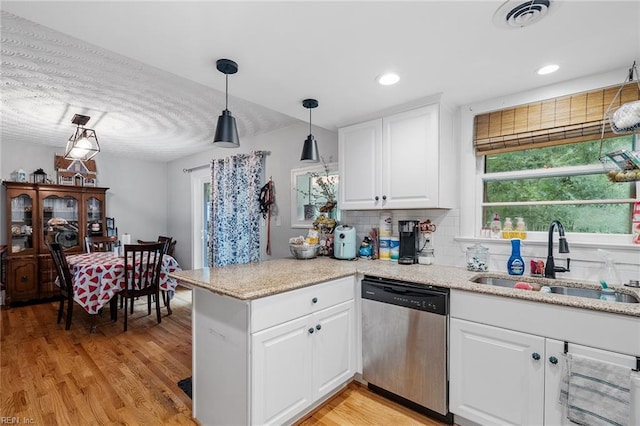 kitchen with light hardwood / wood-style floors, sink, white cabinetry, kitchen peninsula, and stainless steel dishwasher