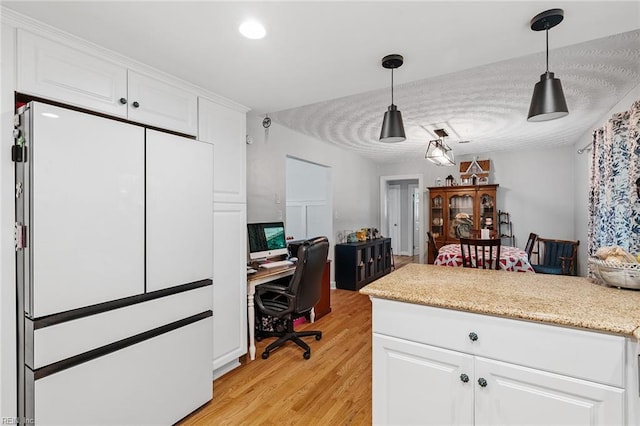 office space featuring a textured ceiling and light hardwood / wood-style floors