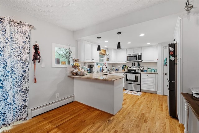 kitchen featuring appliances with stainless steel finishes, white cabinetry, kitchen peninsula, light hardwood / wood-style flooring, and a baseboard heating unit