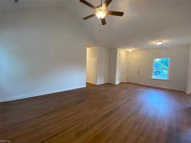 empty room featuring ceiling fan, dark wood-type flooring, and high vaulted ceiling