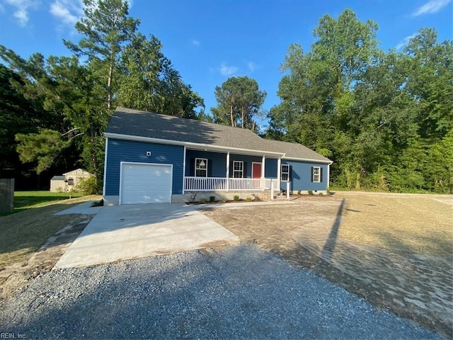 ranch-style house featuring a garage and covered porch