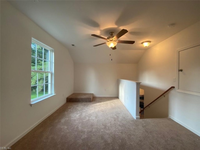 additional living space with ceiling fan, vaulted ceiling, and carpet flooring