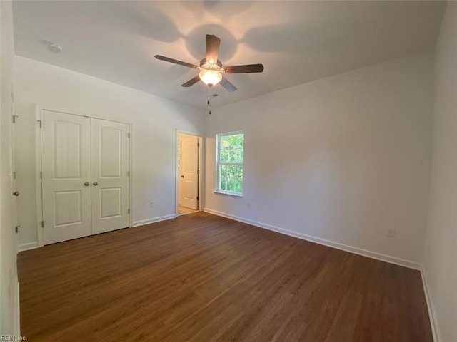 unfurnished bedroom with dark wood-type flooring and ceiling fan