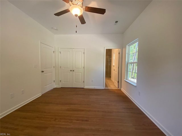 unfurnished bedroom with dark hardwood / wood-style floors and ceiling fan