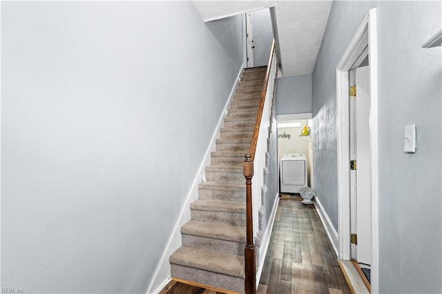 staircase featuring washer / clothes dryer and hardwood / wood-style flooring