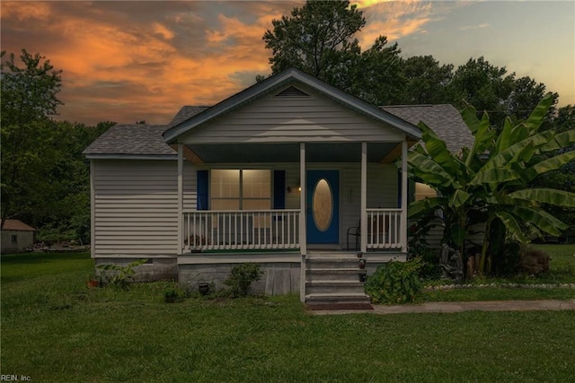 view of front facade with a yard and a porch