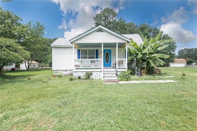 bungalow featuring a porch and a front lawn