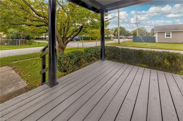 wooden terrace with a lawn