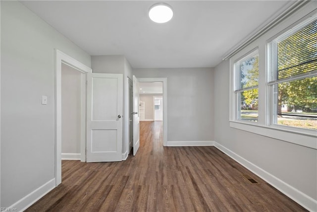 empty room with dark hardwood / wood-style floors