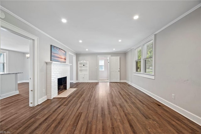 unfurnished living room featuring dark hardwood / wood-style floors, a fireplace, and crown molding