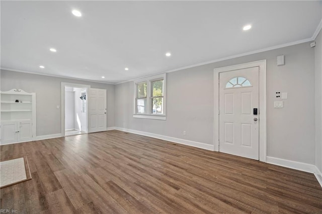 foyer featuring ornamental molding and hardwood / wood-style flooring