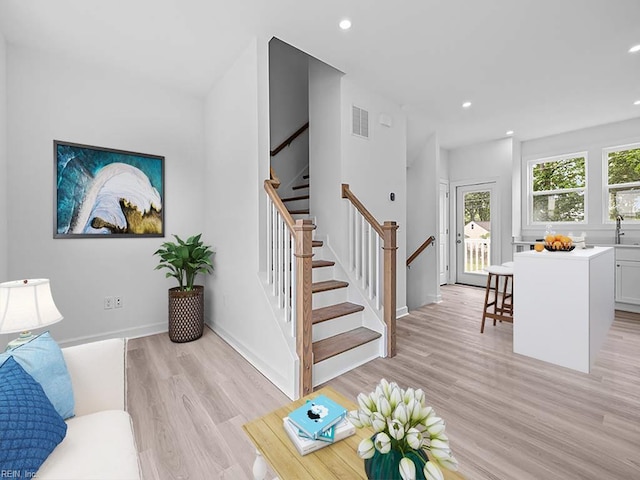 living room featuring light hardwood / wood-style floors and sink