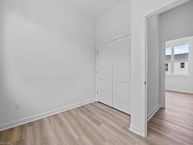 unfurnished bedroom with light hardwood / wood-style floors and a closet