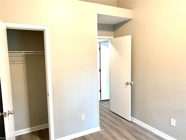 unfurnished bedroom with light wood-type flooring and a closet