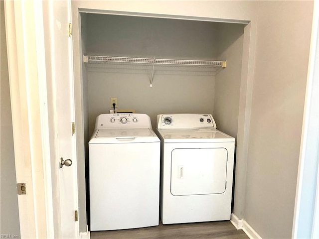 laundry area with hardwood / wood-style floors and washing machine and dryer