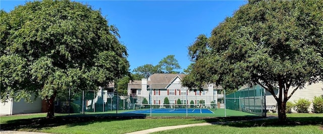 exterior space with a lawn and tennis court