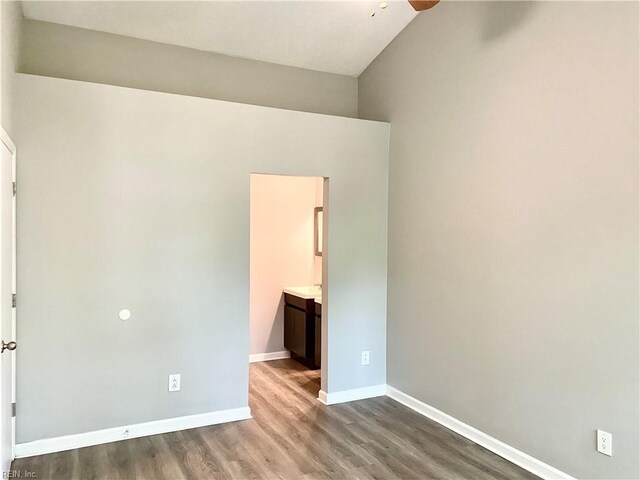 spare room with vaulted ceiling, ceiling fan, and light hardwood / wood-style flooring