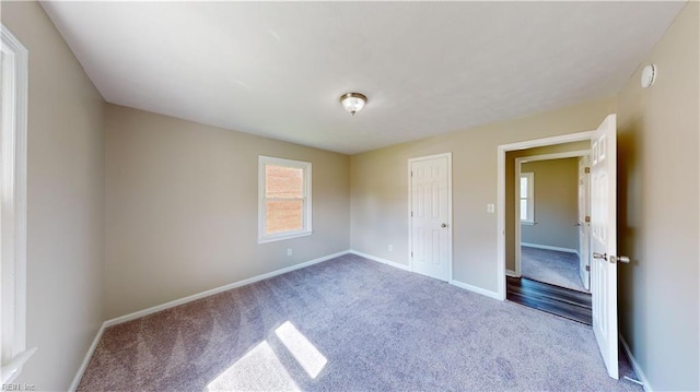 unfurnished bedroom featuring carpet and a closet