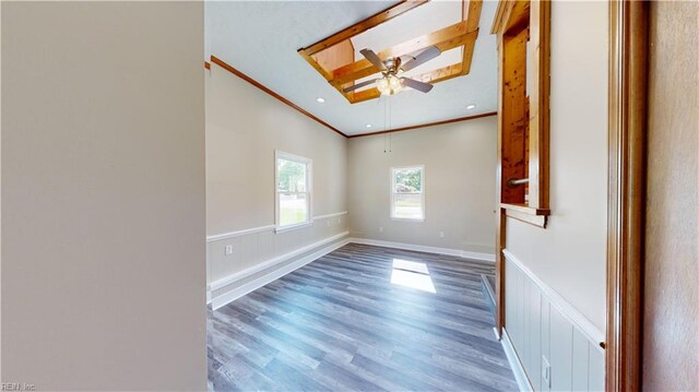 unfurnished room with wood-type flooring, ornamental molding, and ceiling fan