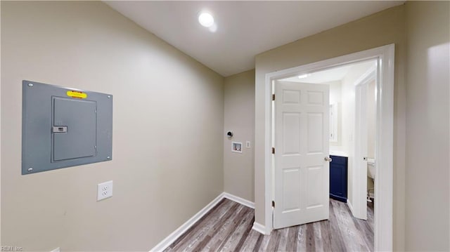 clothes washing area featuring hookup for a washing machine, electric panel, and hardwood / wood-style floors