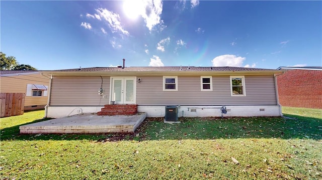 rear view of house featuring a yard, central AC unit, and a patio area