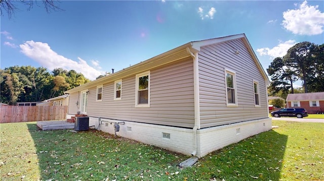 view of property exterior featuring a lawn and central air condition unit