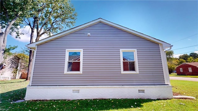 view of side of property with a lawn