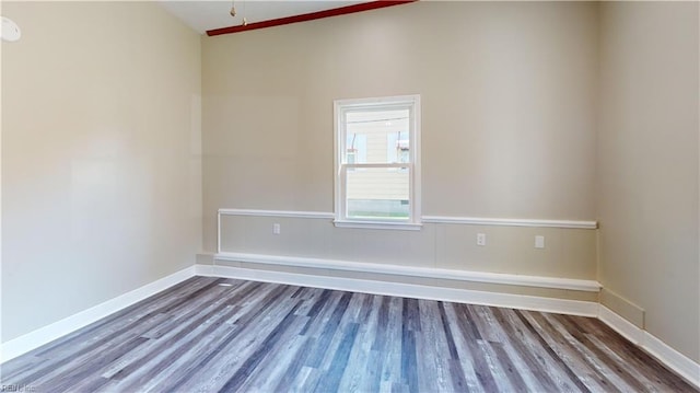 empty room with wood-type flooring and high vaulted ceiling