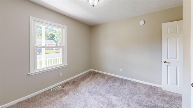 unfurnished room featuring light carpet