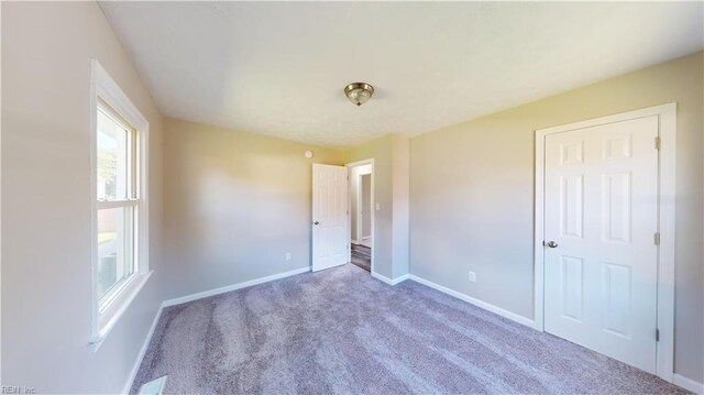 unfurnished bedroom featuring carpet