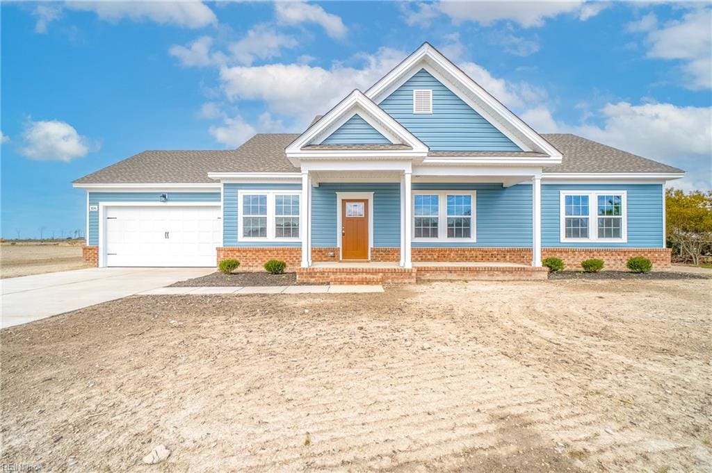 view of front of house with covered porch and a garage