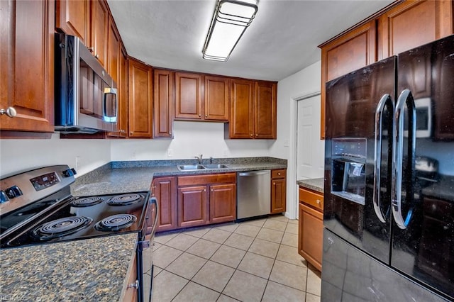 kitchen with stainless steel appliances, light tile patterned floors, and sink