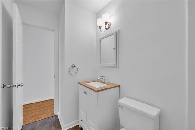 bathroom featuring hardwood / wood-style flooring, vanity, and toilet