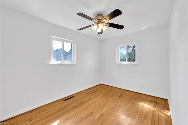 unfurnished room with light hardwood / wood-style flooring, ceiling fan, and a wealth of natural light