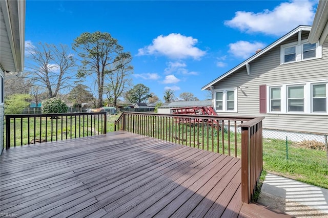 wooden terrace featuring a lawn