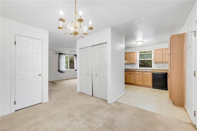 kitchen with black dishwasher, ceiling fan with notable chandelier, light carpet, light brown cabinets, and decorative light fixtures