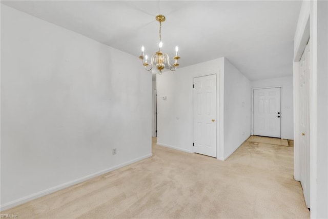 unfurnished dining area with a chandelier and light colored carpet