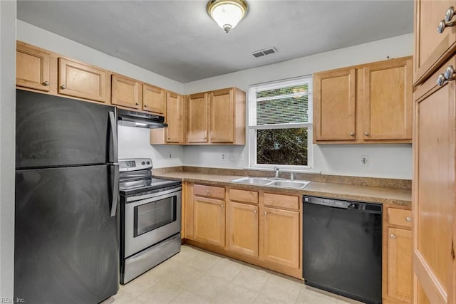 kitchen featuring black appliances, light brown cabinetry, and sink