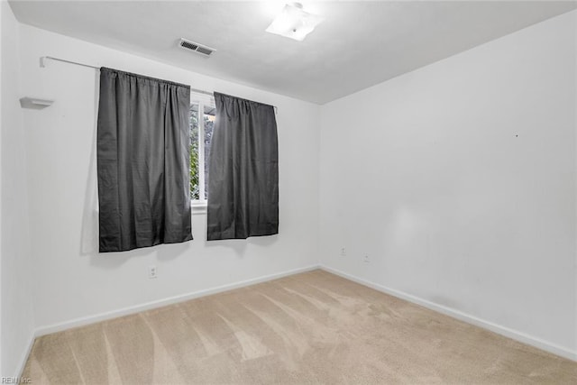 spare room with light colored carpet